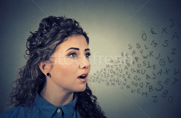 Woman talking with alphabet letters coming out of her mouth. Communication concept Stock photo © ichiosea