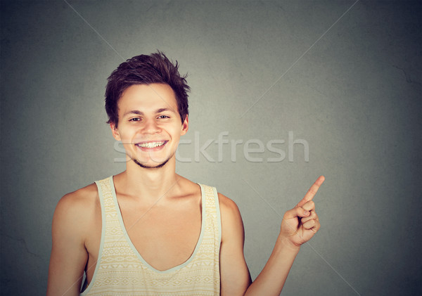 Boldog fiatal mosolyog férfi mutat üres hely Stock fotó © ichiosea