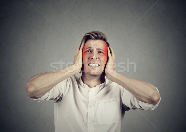 man with headache isolated on gray wall background Stock photo © ichiosea