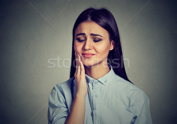 Woman with sensitive toothache crown problem suffering from pain Stock photo © ichiosea