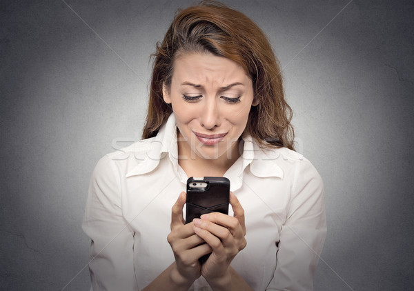 Sad woman looking at mobile phone Stock photo © ichiosea
