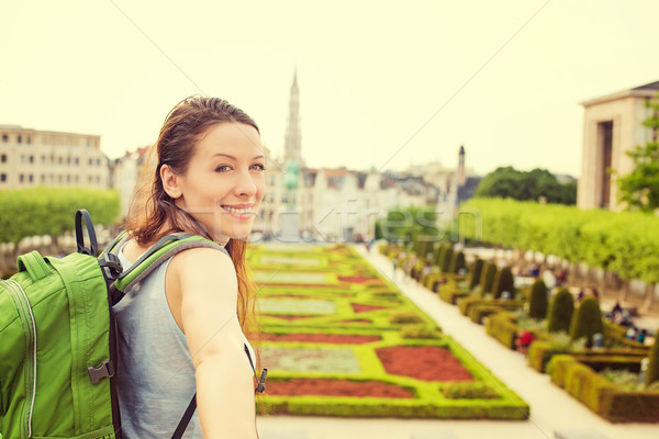 Happy woman in Brussels downtown extending you arm inviting to visit Mont des Arts garden  Stock photo © ichiosea