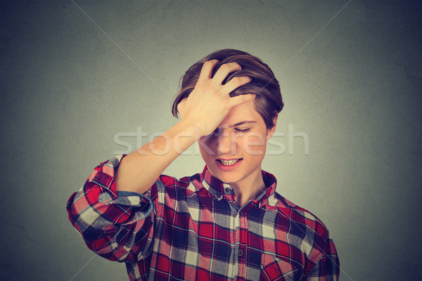 silly young man, slapping hand on head having a duh moment  Stock photo © ichiosea