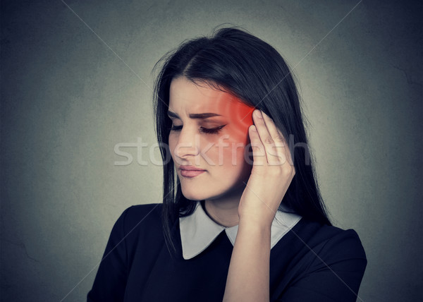Tinnitus. Sick woman having ear pain colored in red head Stock photo © ichiosea