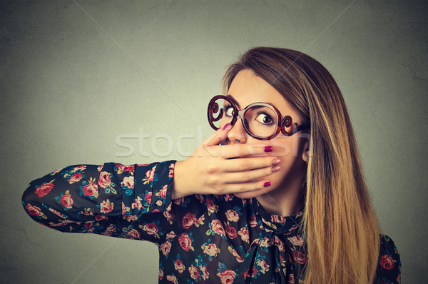 Closeup portrait of scared young woman in glasses covering with hand her mouth Stock photo © ichiosea