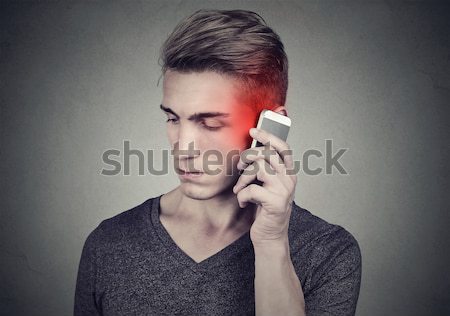 Stock photo: Happy young man liar with long nose talking on mobile phone 