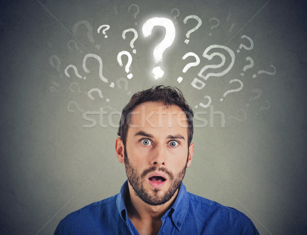 Shocked young man with many questions and no explanation or answer   Stock photo © ichiosea