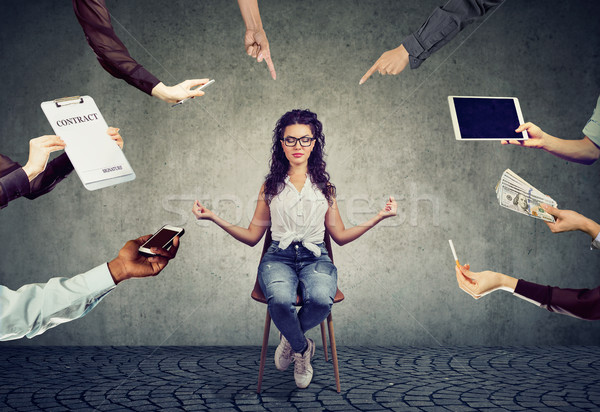 Young woman is meditating to relieve stress of busy corporate life  Stock photo © ichiosea