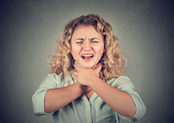 Young woman having asthma attack or choking can't breath Stock photo © ichiosea