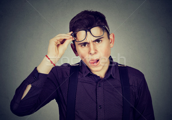 Stock photo: Funny looking skeptical man in glasses