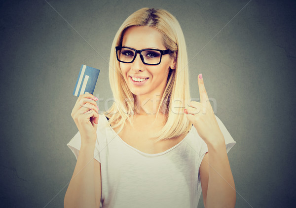 Happy woman wearing glasses holding showing number one credit card Stock photo © ichiosea