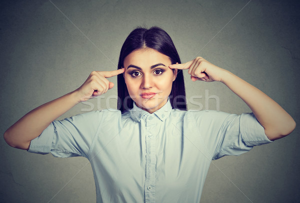 Angry woman gesturing with finger against temple are you crazy?  Stock photo © ichiosea