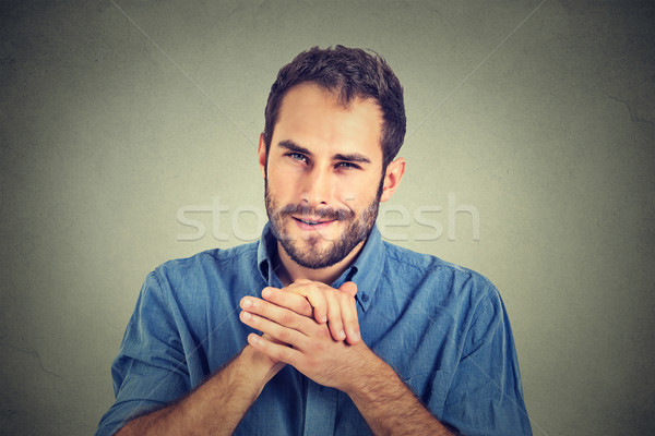 Stock photo: Sneaky scheming young man, worker trying to plot something
