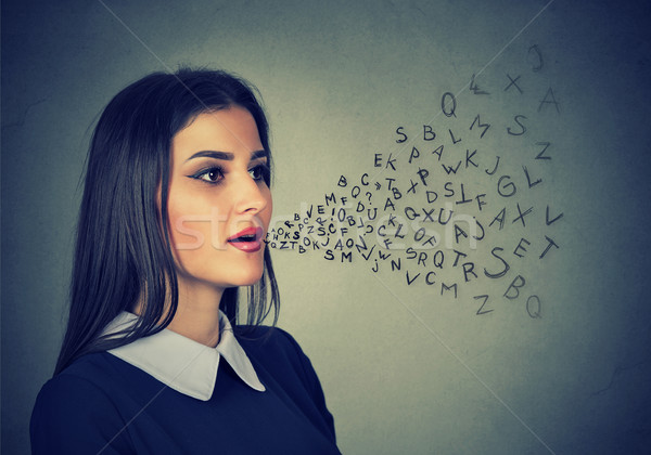 Woman talking with alphabet letters coming out of her mouth Stock photo © ichiosea