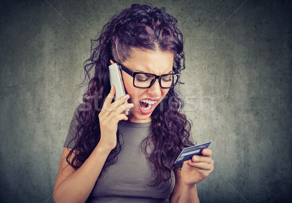 Screaming angry woman solving problems with credit card Stock photo © ichiosea