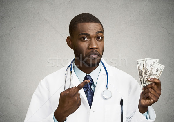 Greedy health care professional, doctor holding cash, money Stock photo © ichiosea