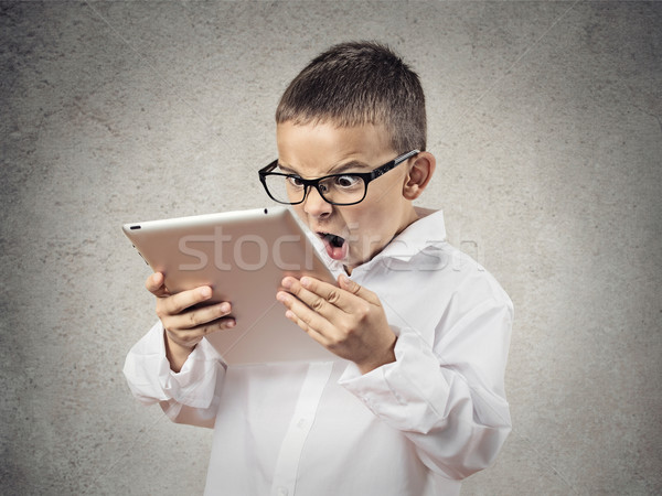 Shocked, frustrated boy using pad computer Stock photo © ichiosea