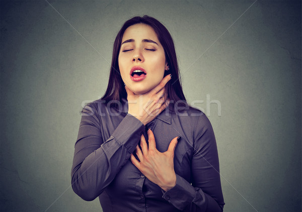 Woman having asthma attack or choking can't breath suffering from respiration problems  Stock photo © ichiosea