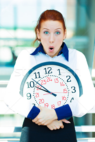 Anxious businesswoman holding clock Stock photo © ichiosea