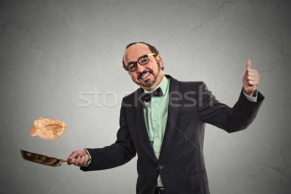 smiling man tossing pancakes on frying pan Stock photo © ichiosea