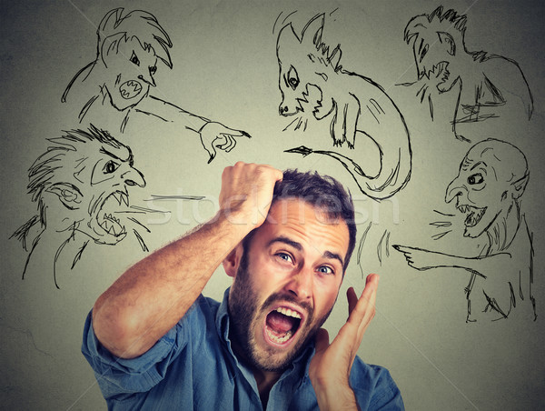 Evil men pointing at stressed anxious guy Stock photo © ichiosea