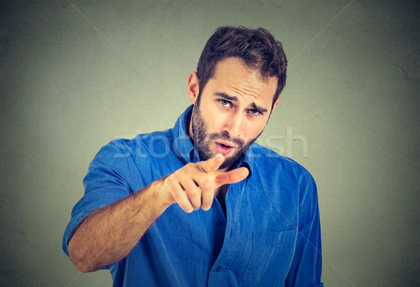 portrait of a angry young man pointing finger at someone  Stock photo © ichiosea