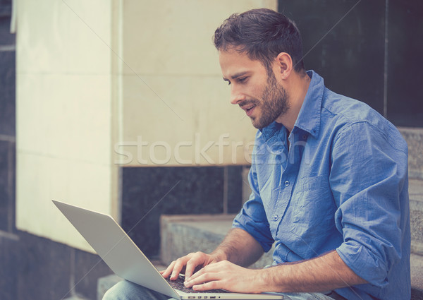 Przystojny młodych szczęśliwy biznesmen pracy laptop Zdjęcia stock © ichiosea