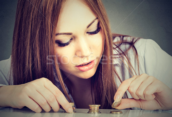 Woman counting money stacking up coins   Stock photo © ichiosea