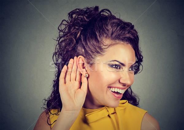 Woman with hand near ear listening carefully and smiling  Stock photo © ichiosea