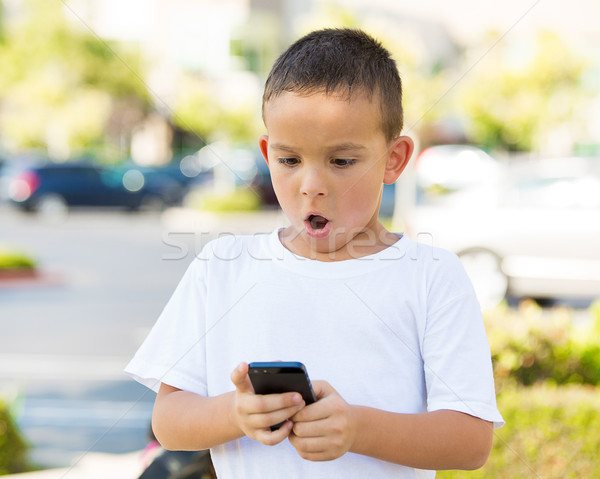 Surprised boy looking at his smart phone Stock photo © ichiosea