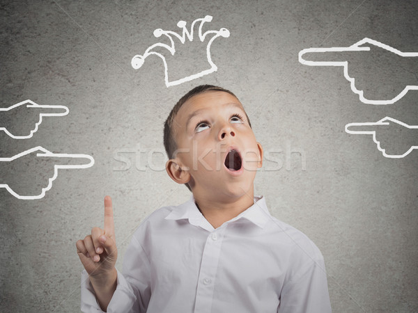 Stock photo: Surprised boy pointing, looking up at his crown