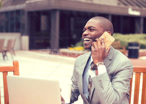 businessman working on laptop outdoors talking on mobile phone Stock photo © ichiosea