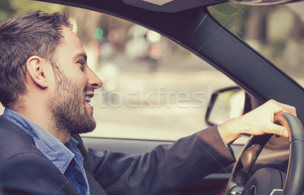 Happy smiling young man driving his new car.  Stock photo © ichiosea