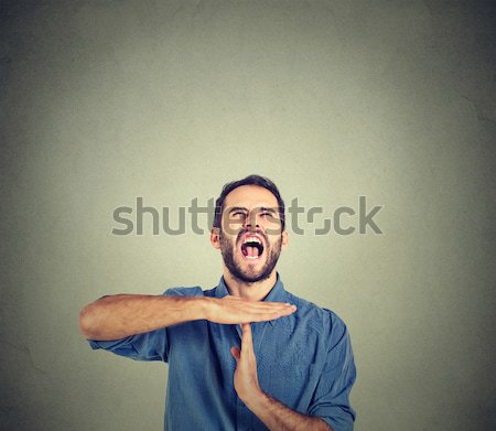 Stock photo: Young man showing time out hand gesture, frustrated screaming