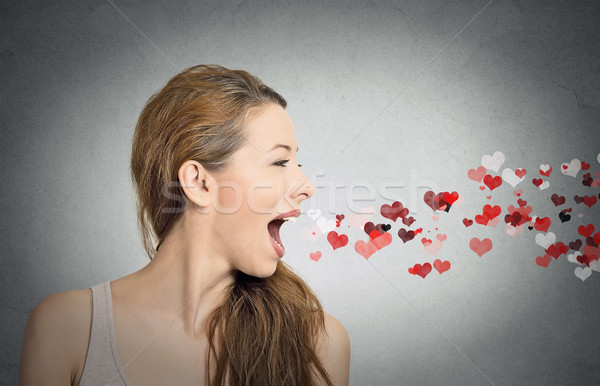 Stock photo: woman sending kisses, red hearts coming out of open mouth