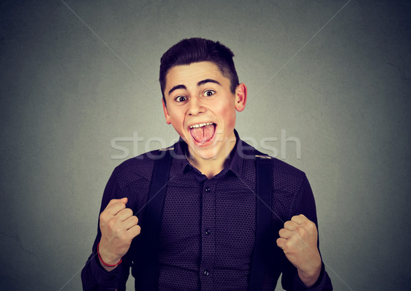 Happy successful student man winning fists pumped celebrating success  Stock photo © ichiosea