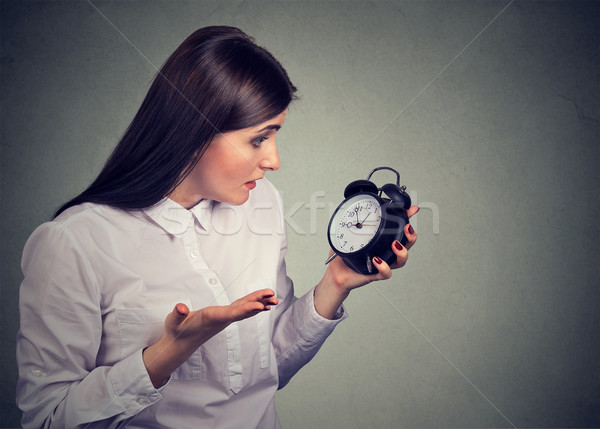 Portrait of upset stressed looking woman with alarm clock Stock photo © ichiosea