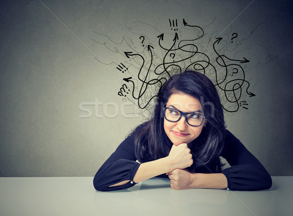Business woman thinking contemplating a solution sitting at table  Stock photo © ichiosea