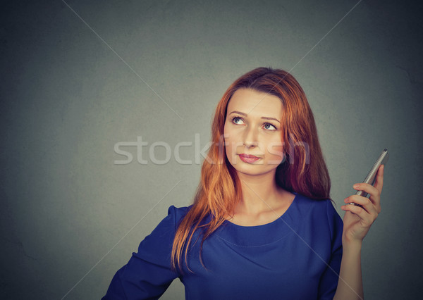 Portrait of an annoyed and frustrated young woman on the phone  Stock photo © ichiosea