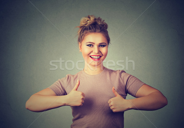 Happy smiling woman with thumbs up gesture.  Stock photo © ichiosea