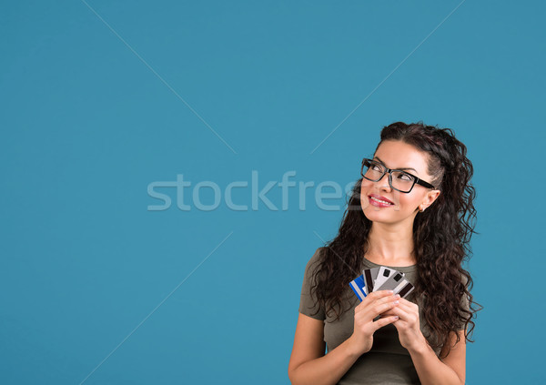 Playful brunette woman is thinking of online shopping in internet  Stock photo © ichiosea