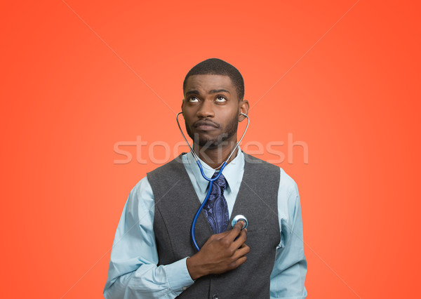 Executive man listening  to his heart, self criticism concept Stock photo © ichiosea