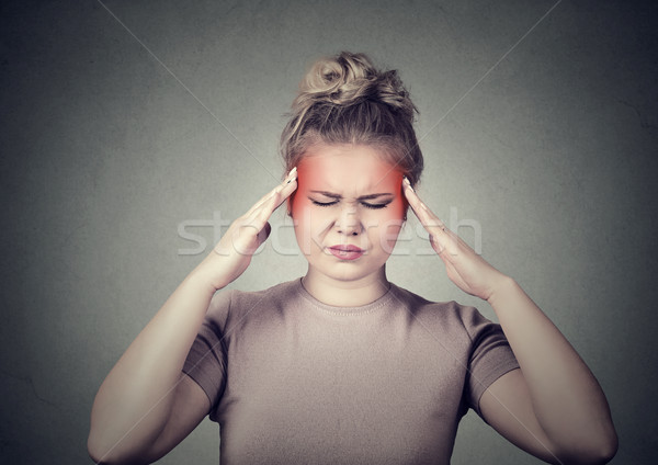 woman with headache, migraine, stress, insomnia temples colored in red Stock photo © ichiosea