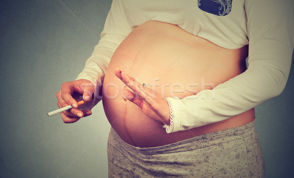 No smoking during pregnancy. Pregnant young woman and smoking concept.  Stock photo © ichiosea