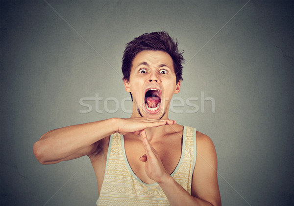 Young man showing time out hand gesture, frustrated screaming Stock photo © ichiosea