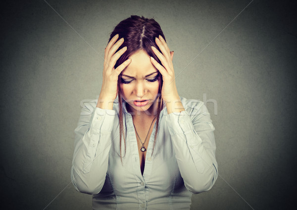 sad woman with worried stressed face expression looking down Stock photo © ichiosea