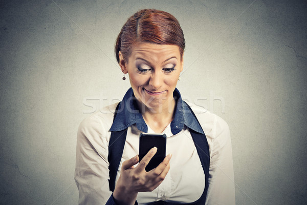 displeased young businesswoman reading bad news on smart phone Stock photo © ichiosea