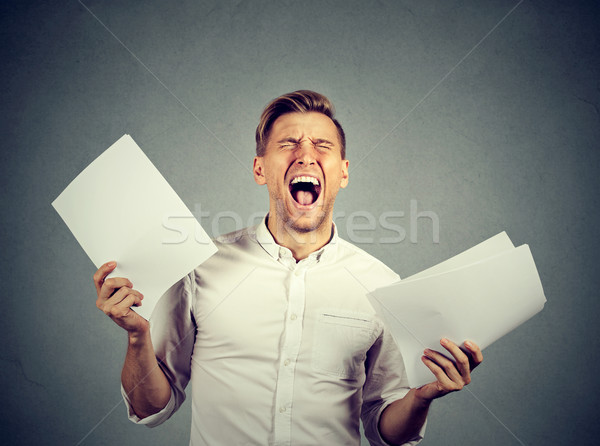 Angry stressed screaming business man with documents papers Stock photo © ichiosea