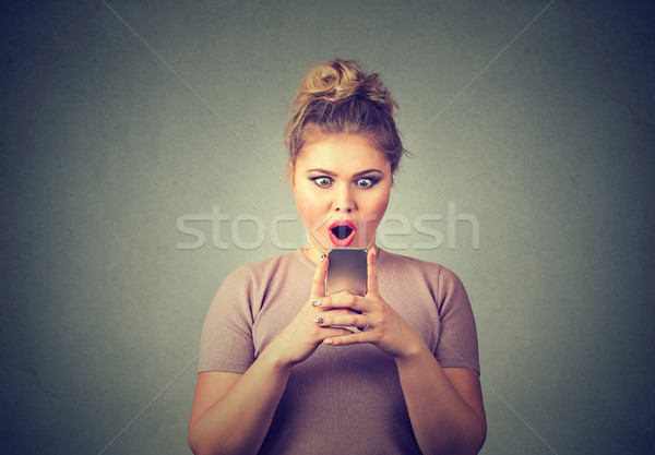 anxious amazed girl looking at phone seeing bad news with disgusting emotion on face Stock photo © ichiosea