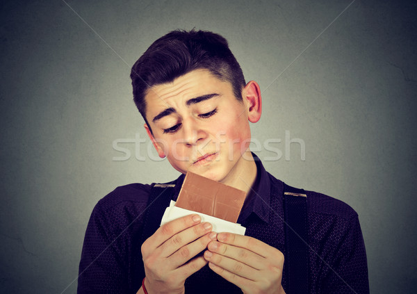 Szomorú fiatalember fáradt diéta sóvárgás csokoládé Stock fotó © ichiosea